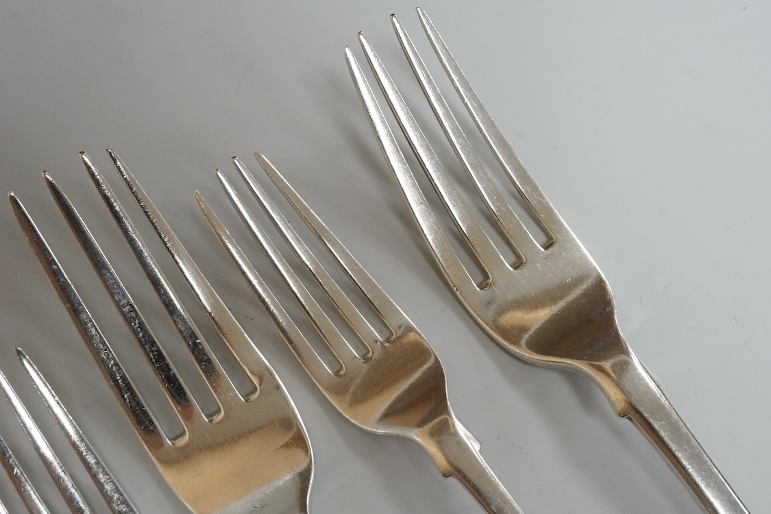 A set of six late George III silver fiddle pattern table forks, Thomas Wilkes Barker, London, 1818, together with five 19th century assorted silver fiddle pattern dessert forks, one broken in half, 18.8oz.